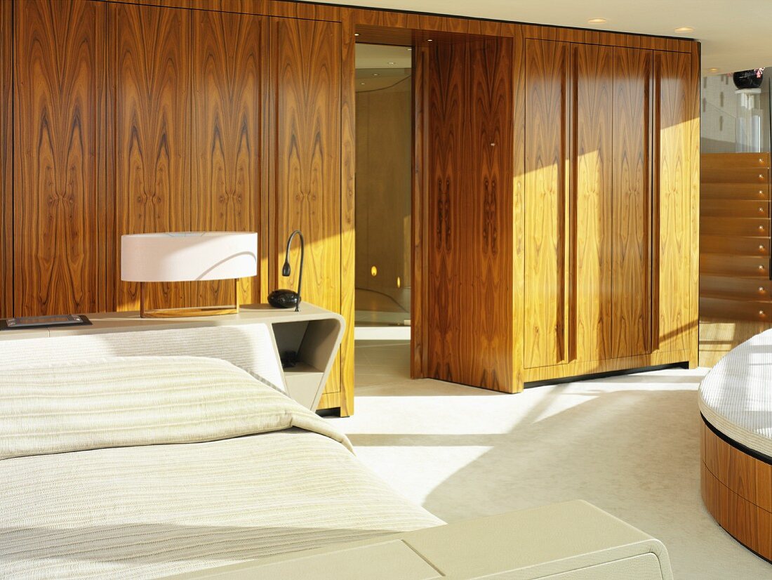 Wooden fitted cupboards as partition in bedroom