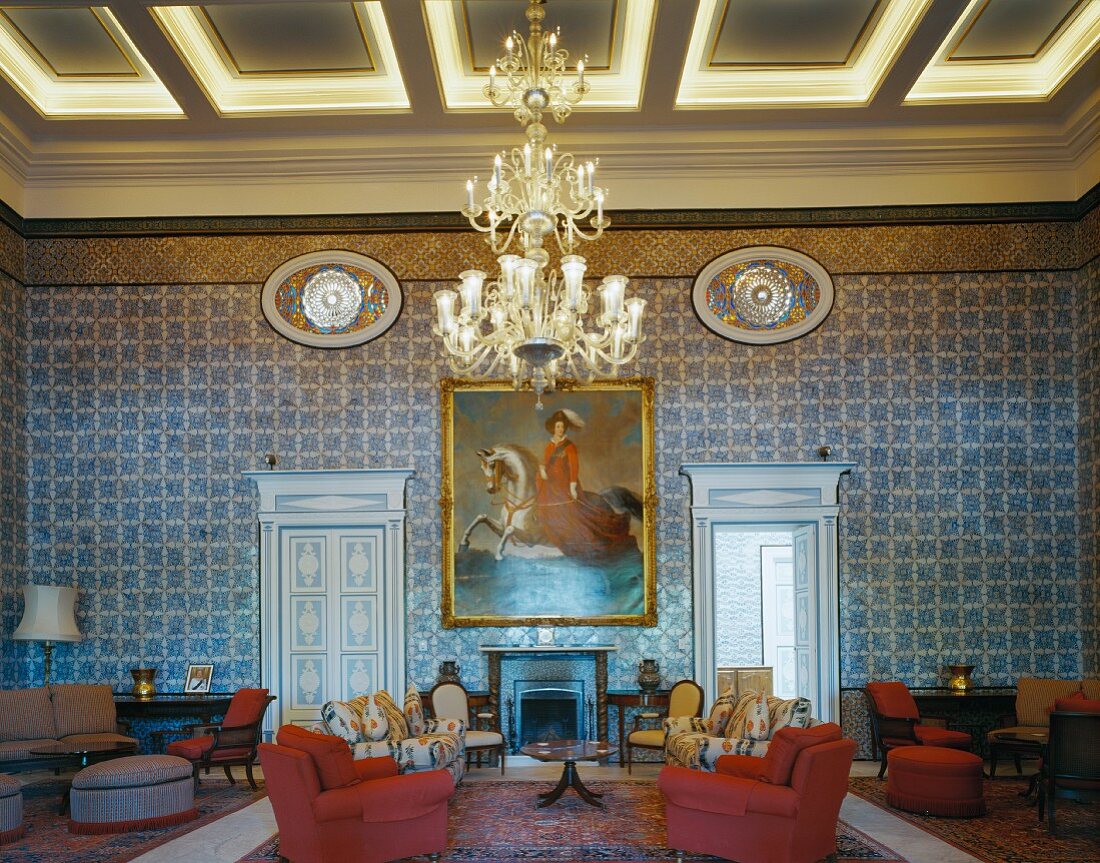 Antique European furniture contrasting with traditional, North African wall mosaics in spacious foyer