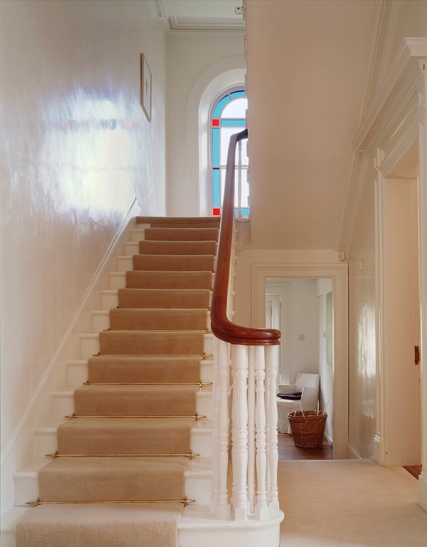 Glossy white wall in traditional stairwell