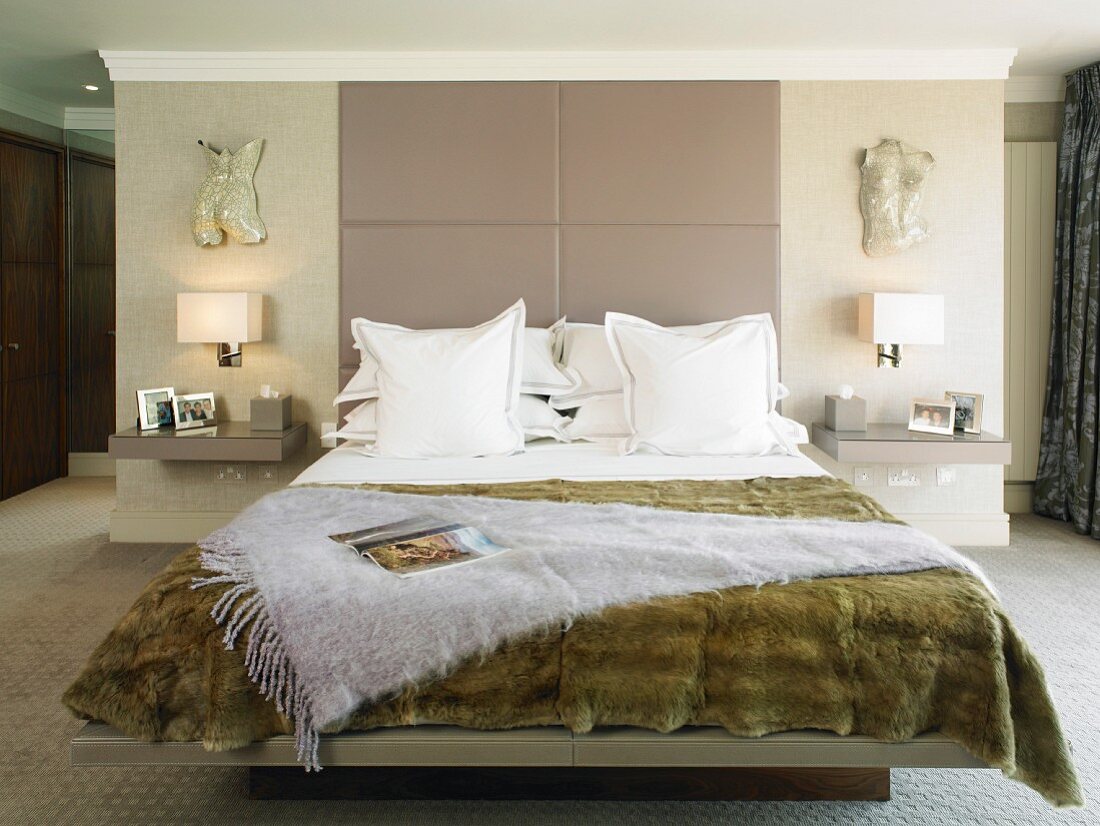 Fur bedspread on double bed in modern bedroom