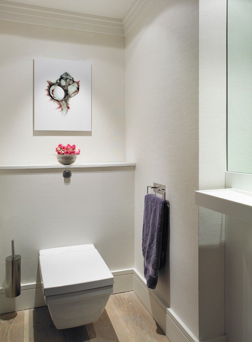 White wall-mounted toilet in modern bathroom