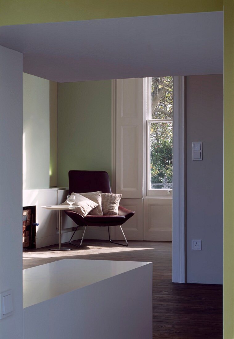 Anteroom with wide doorway and view of armchair in corner of room
