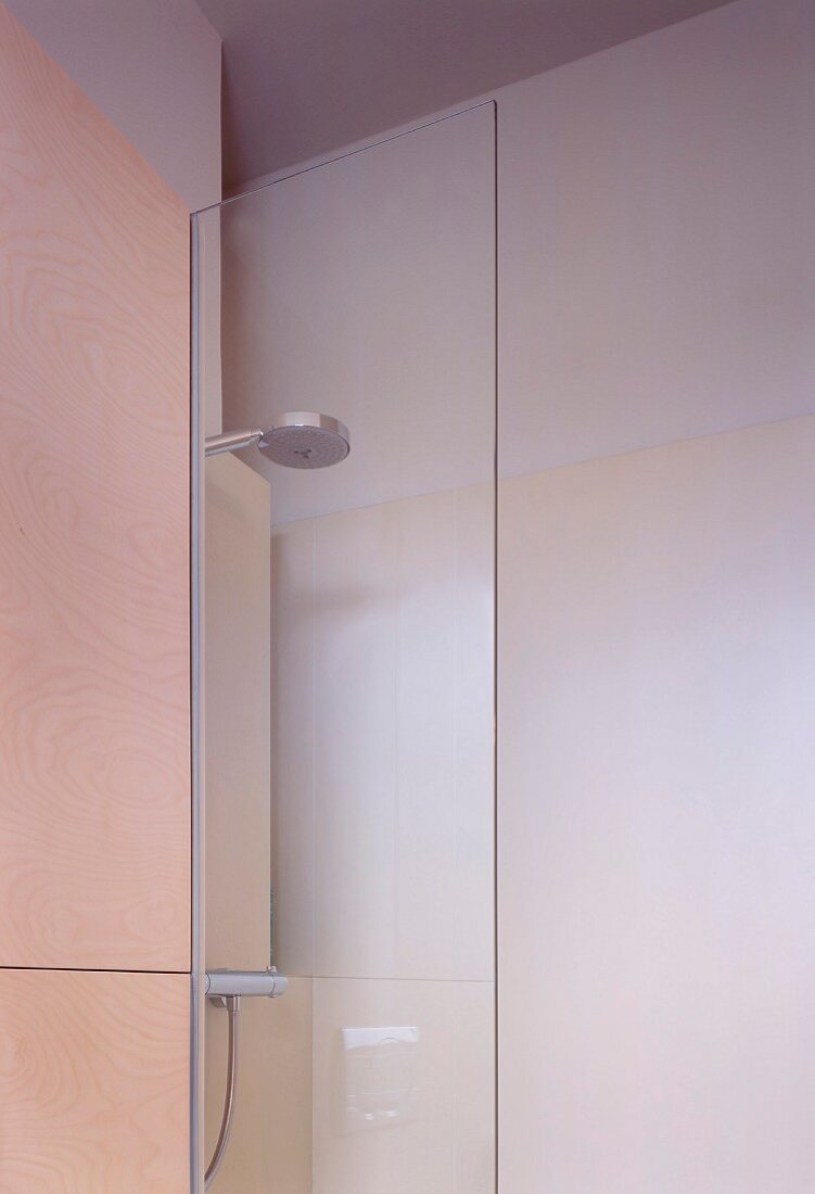 Detail of modern, glass shower cubicle with shower head