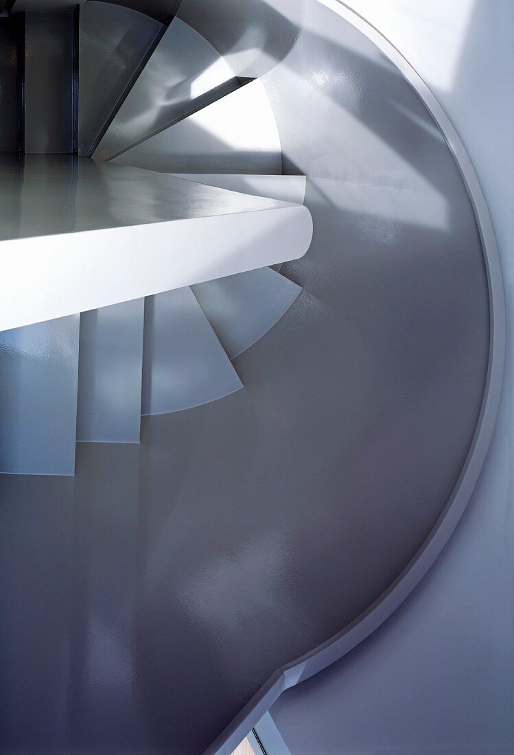 View of spiral staircase with curved stairwell wall