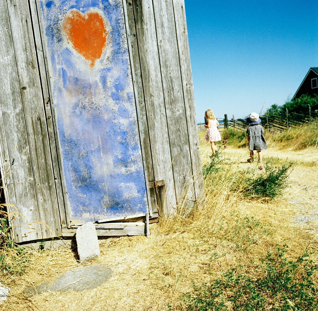 Weathered wooden shed with heart motif
