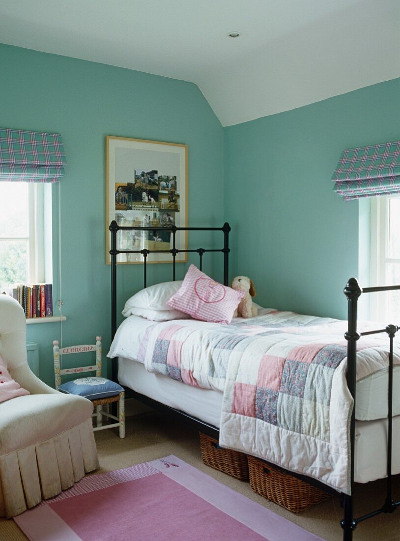 Child's bedroom with bed and patchwork bedspread
