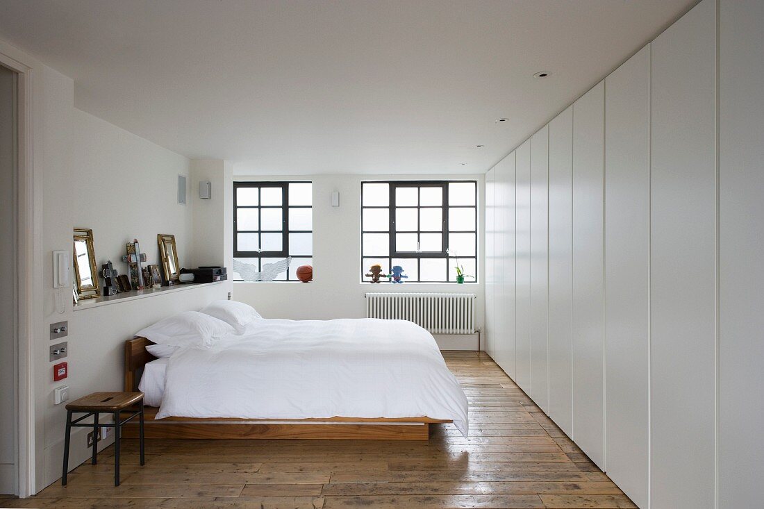 Modern furnishings in bedroom with old floorboards
