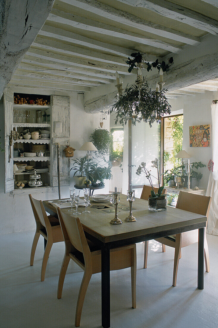 Modern dining table with chairs in rustic dining room