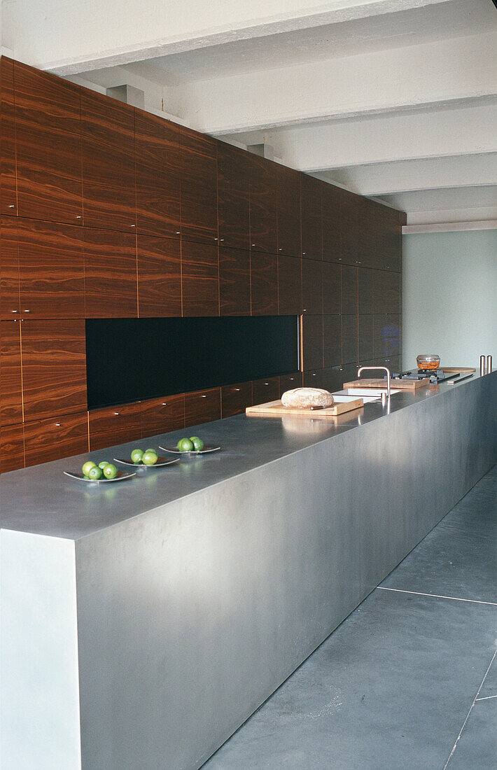 Modern kitchen with wooden cabinets and concrete worktop