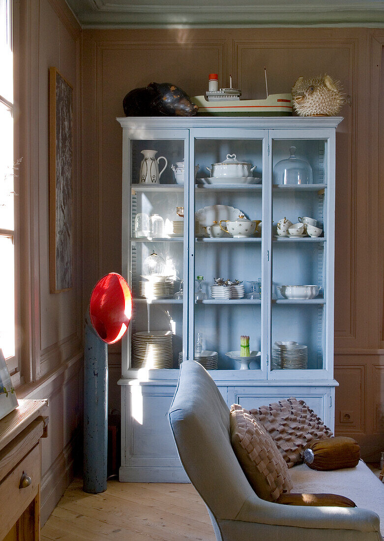 Light blue display cabinet with crockery and maritime decorations