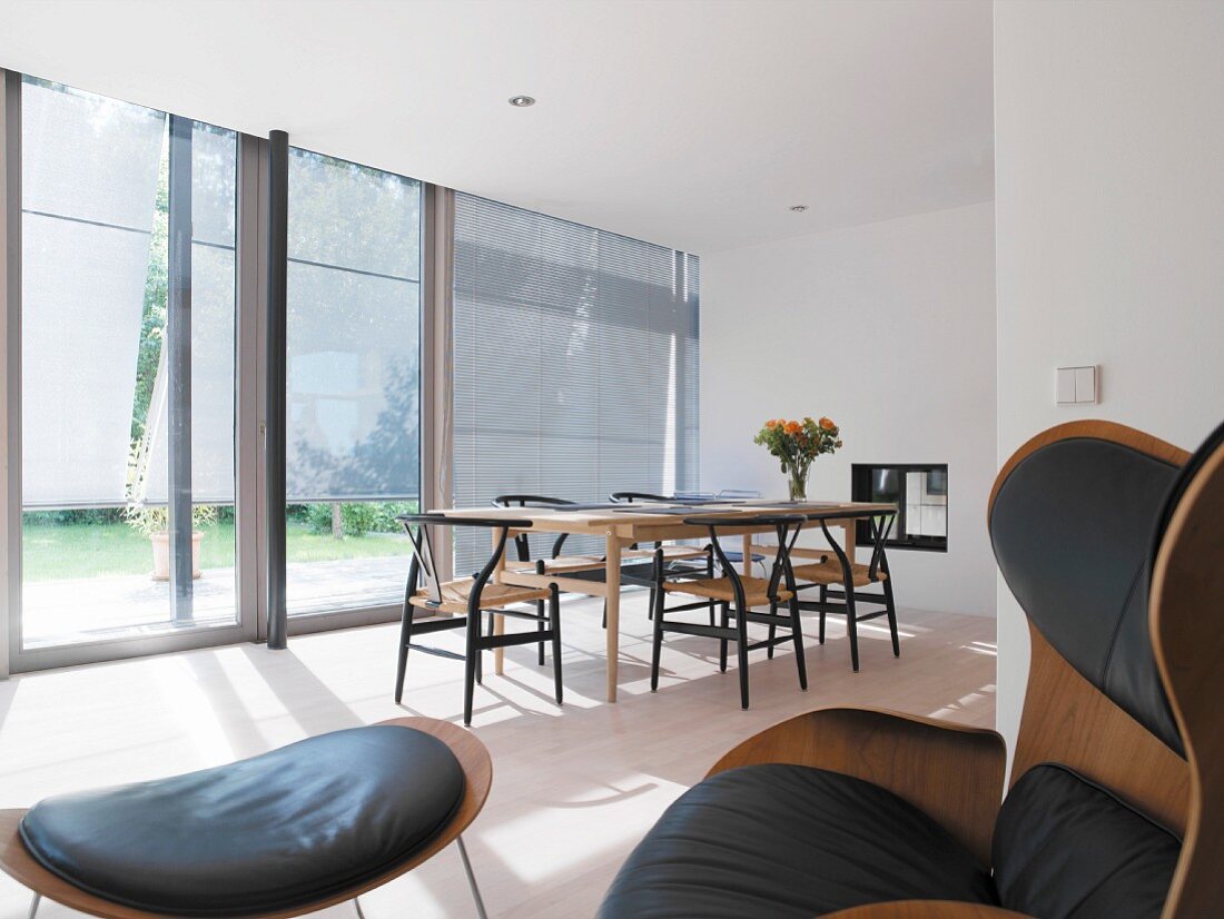 Dining area in open-plan room with glass sliding doors leading to terrace