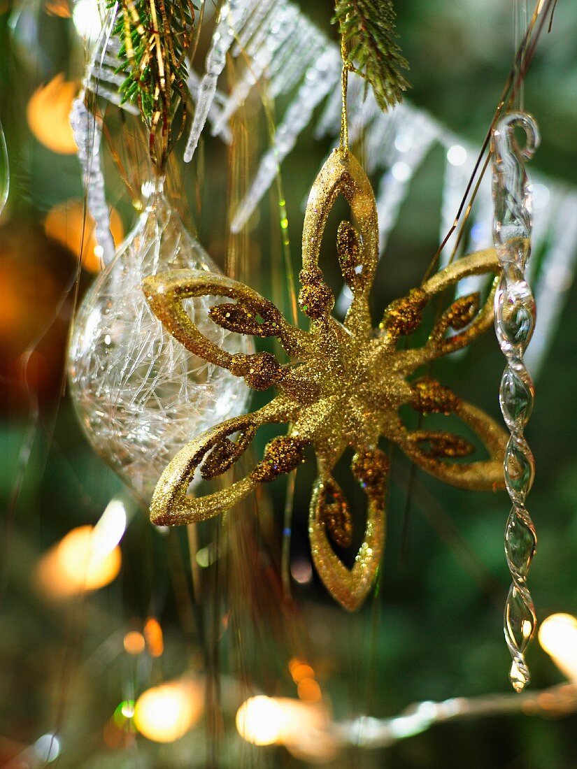 Glittery, gold star Christmas tree decoration