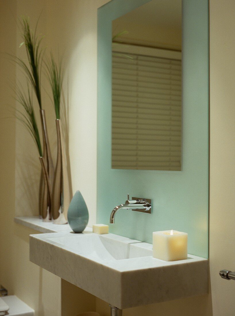 Modern bathroom in pastel tones - designer basin decorated with candles and grasses