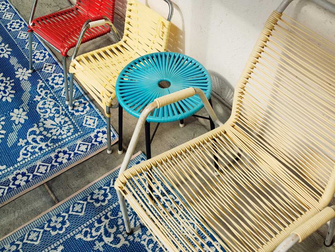 Garden chairs and stool made of woven plastic ropes