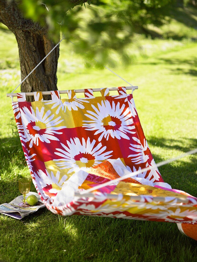 Colorful hammock with white floral pattern in the garden