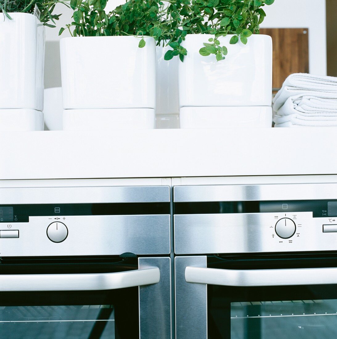 Herb pots on a kitchen counter with built-in kitchen appliance