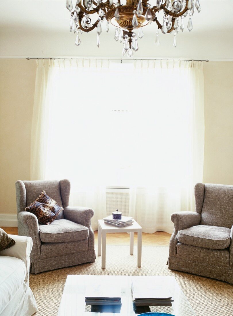 Living room with upholstered furniture and chandelier