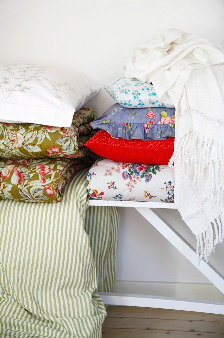 Assorted pillows and bedspreads