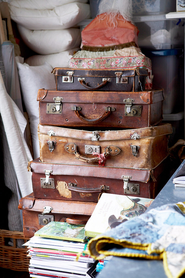 Stack of vintage suitcases in utility room