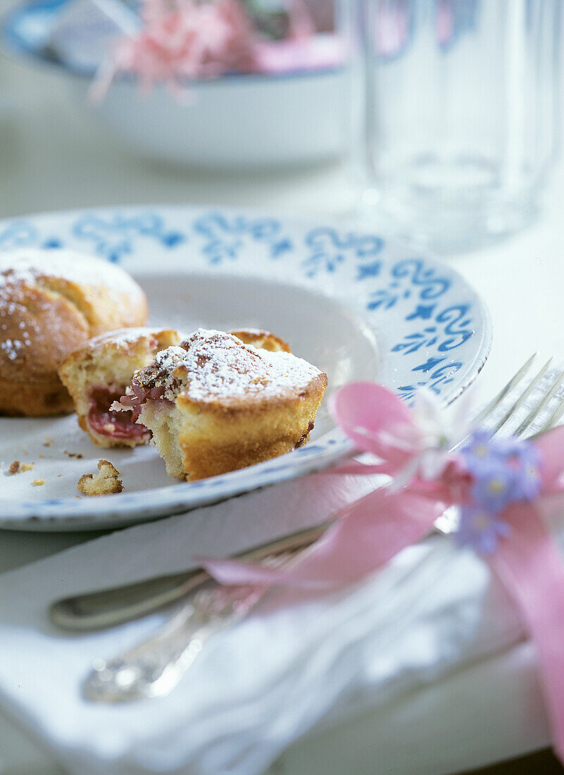 Filled pastries with icing sugar on a plate