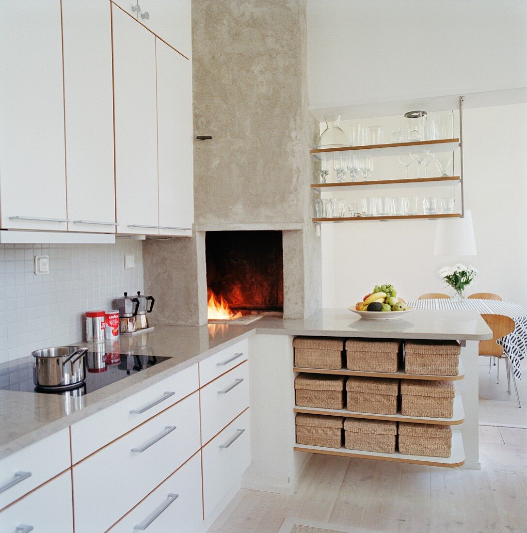 Modern kitchen with white cabinet front and fireplace