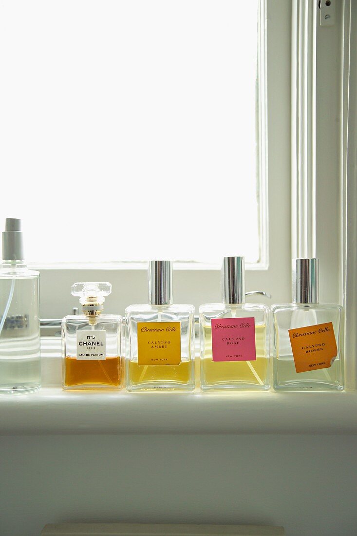 Various flagons of perfume on window sill