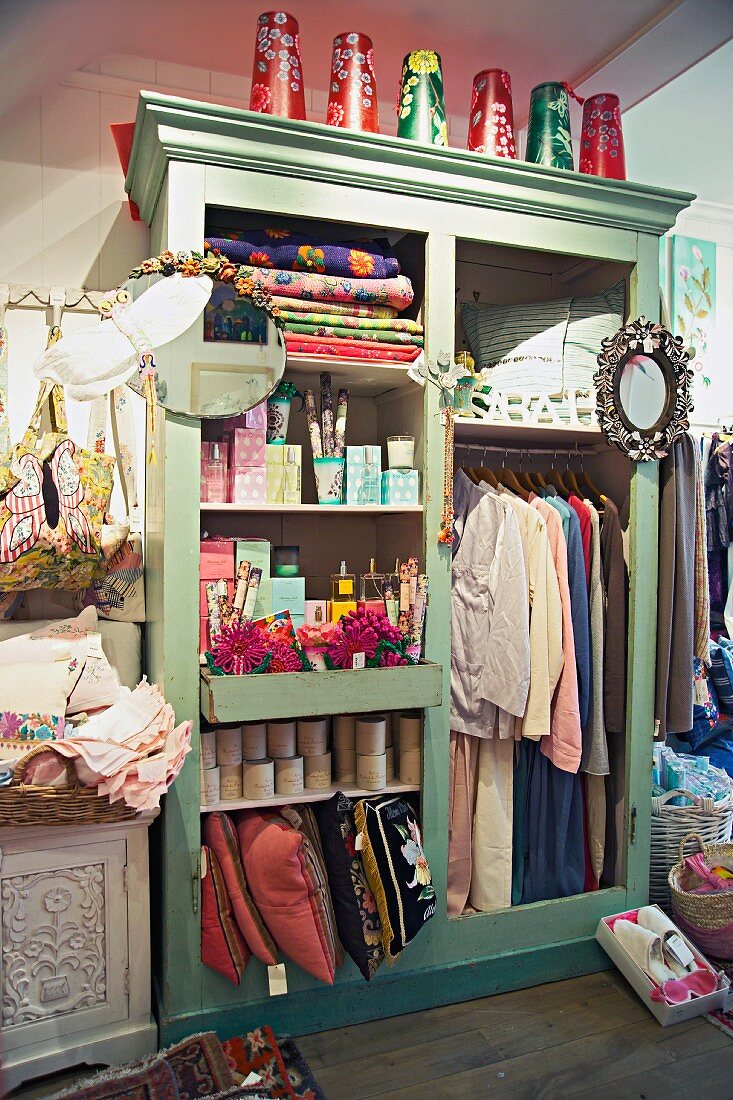 Shabby chic shop - painted wardrobes without doors displaying goods for sale