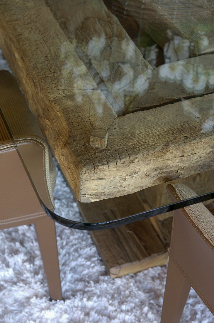Table with glass top on rustic wooden base