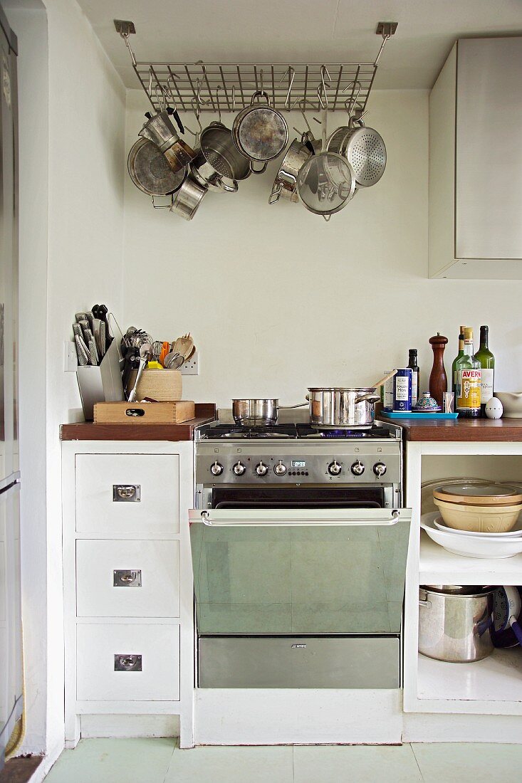 Simple, modern kitchen cabinets with a saucepan hanger on the ceiling