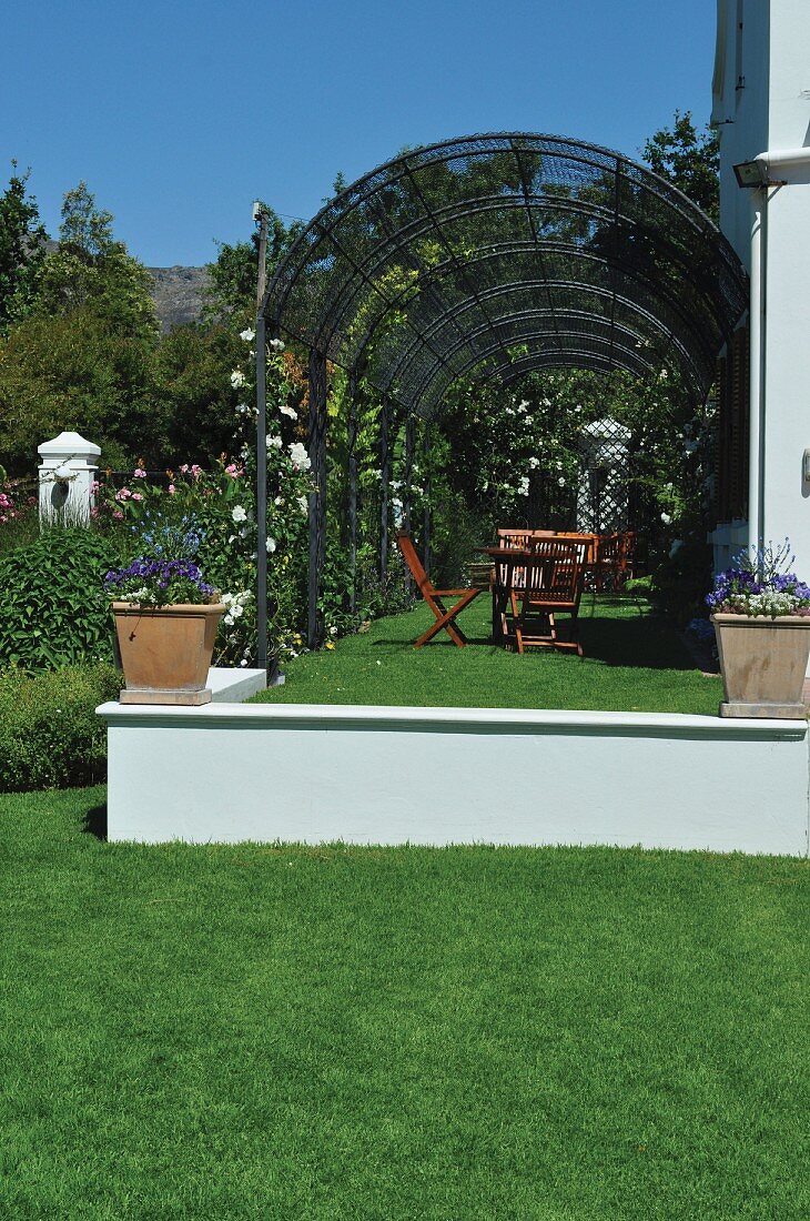 Terrace beneath pergola in garden