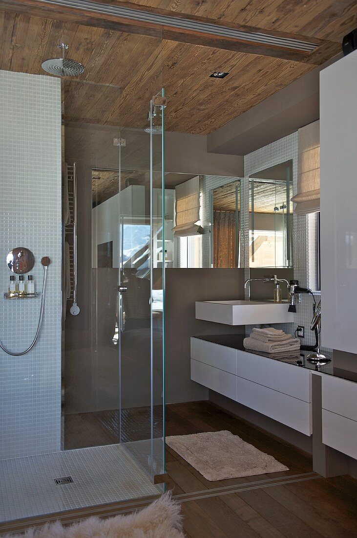 Designer bathroom with shower area in rustic wooden hut