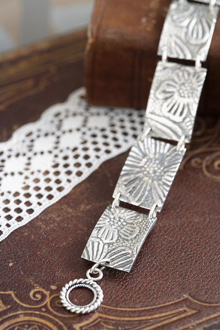 Silver link bracelet made with embossed floral pattern