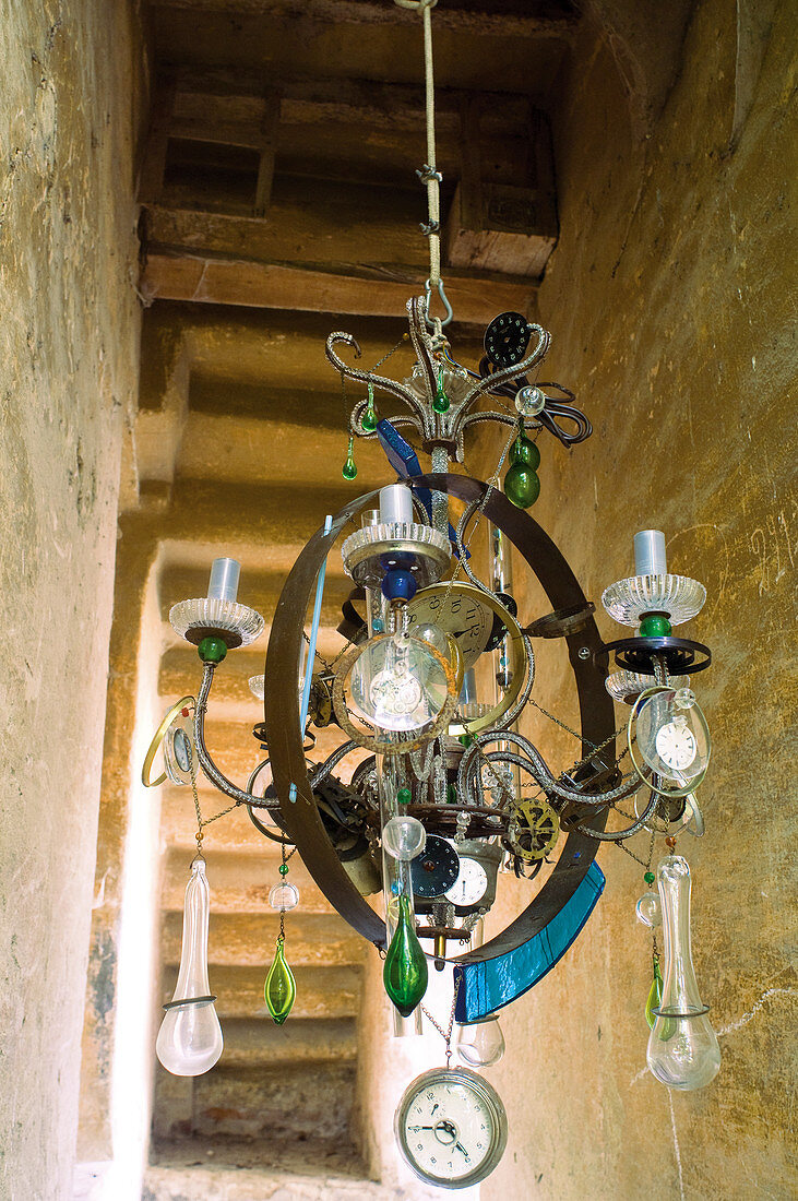 Vintage chandelier decorated with glass droplets and clock ornaments