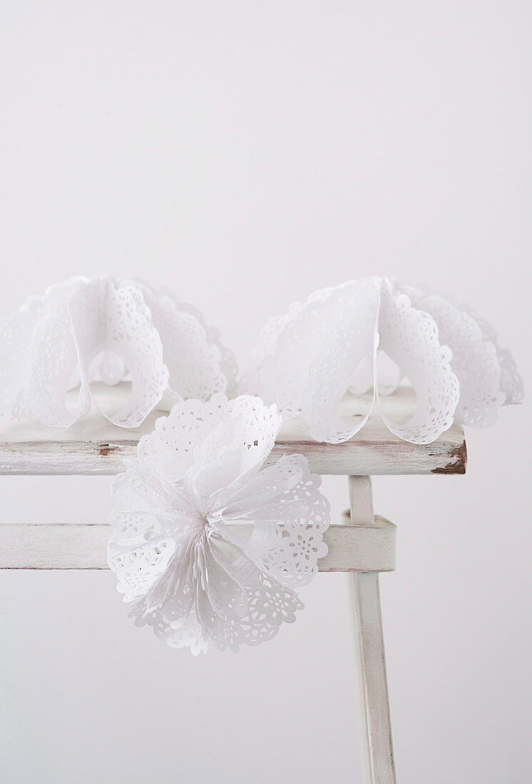 White paper flowers with lacy patterns on vintage table