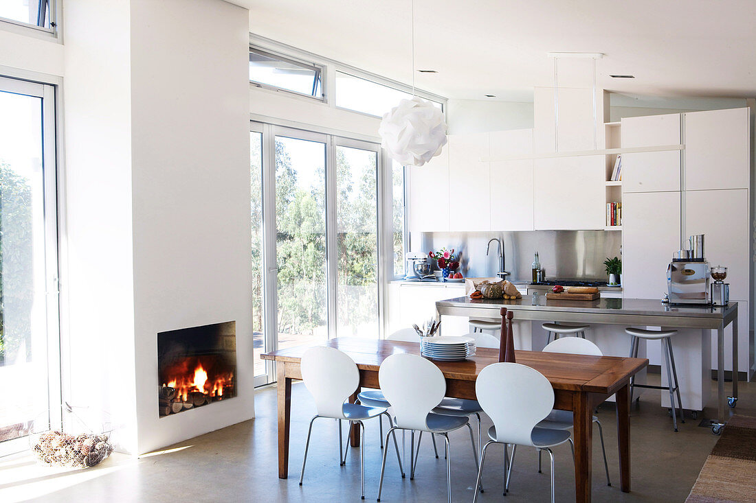 Open-plan kitchen with dining area and fireplace