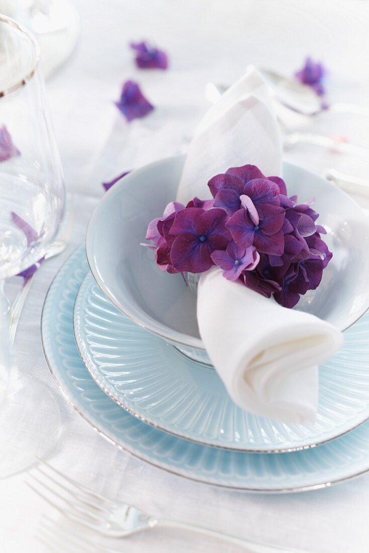 A place setting decorated with hydrangea