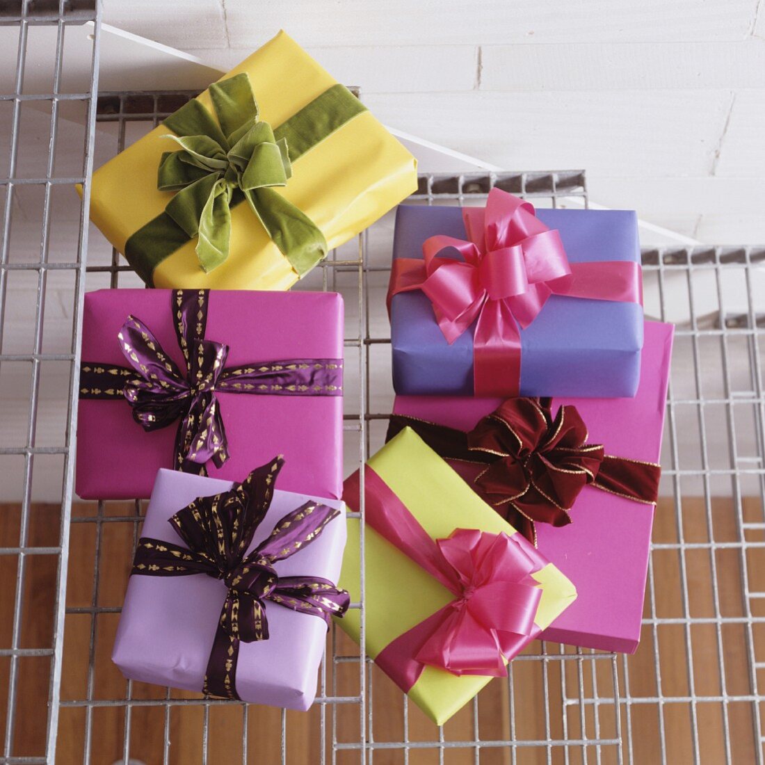 Presents wrapped in plain paper with large bows on white, metal lattice stair treads