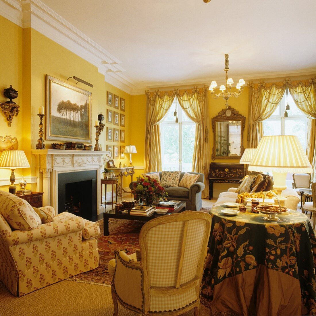 Herrschaftliches Wohnzimmer mit gelb getönten Wänden und verschiedenen Sitzmöbeln vor offenem Kamin
