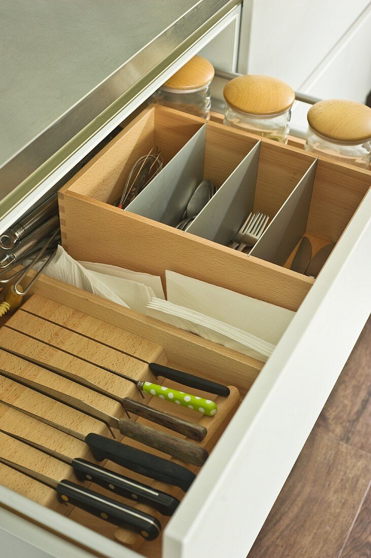 Organised cutlery draw with wooden compartments and knife block