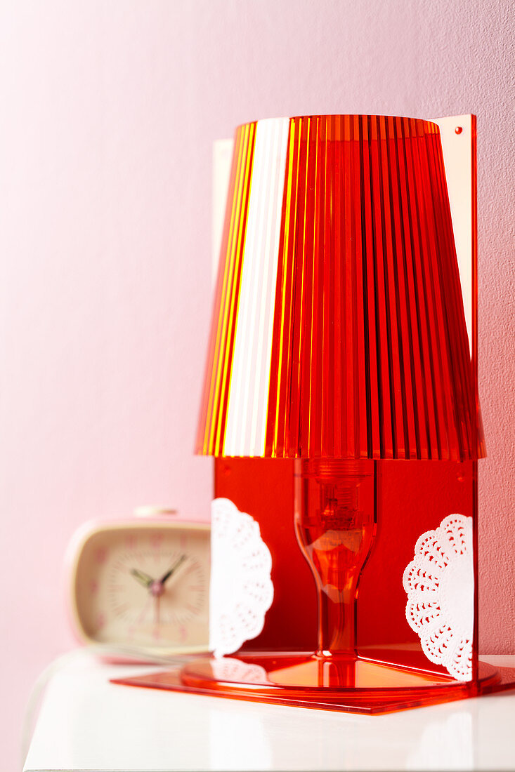 A table lamp decorated with doilies