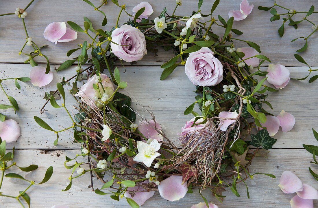 A wreath of pink roses, mistletoe and hellebores