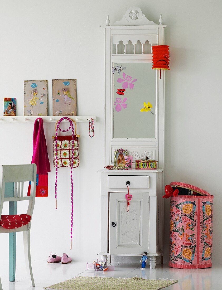 White hallstand with mirror and storage bin with colourful cover