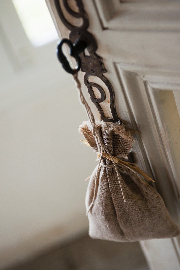 Lavender bag hanging from key in door lock