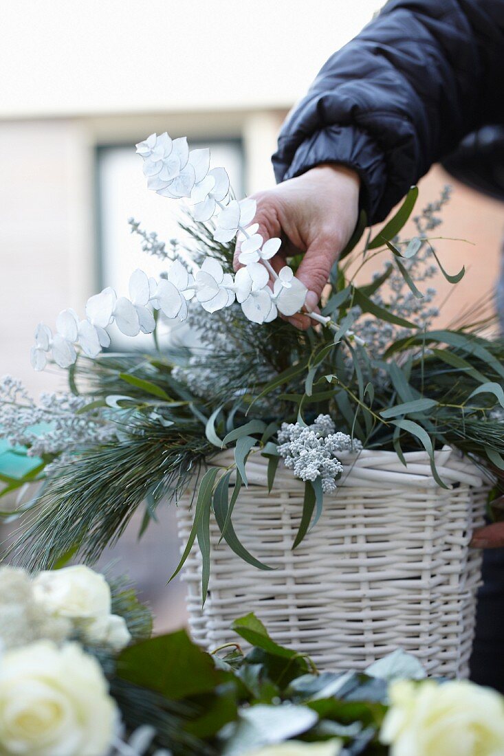 Flower arrangement in white basket