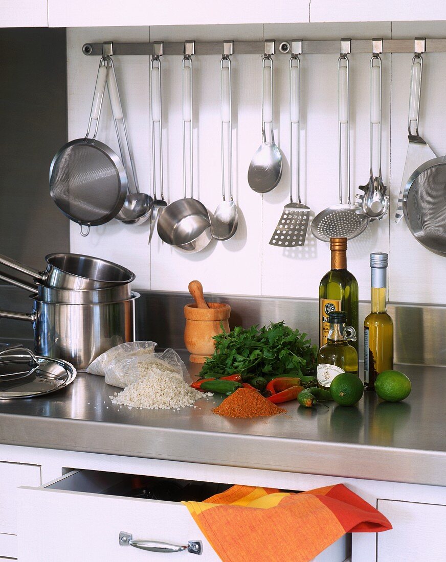 Kitchen utensils and ingredients in a stainless steel kitchen