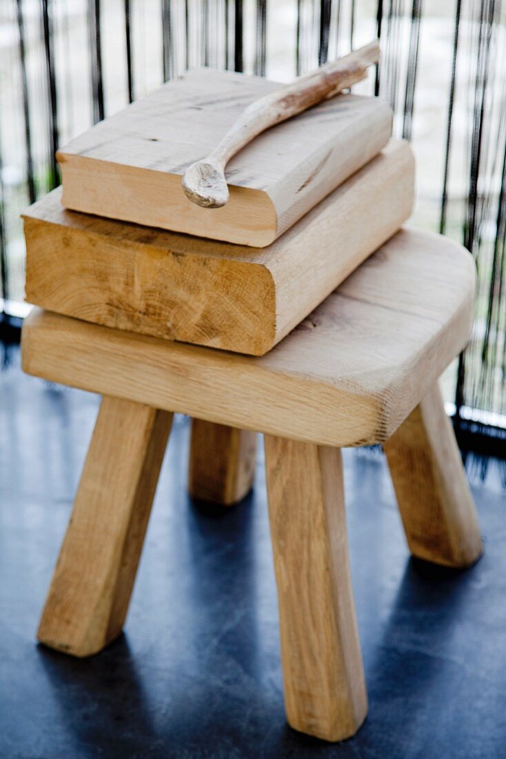 Stack of wood on rustic wooden stool