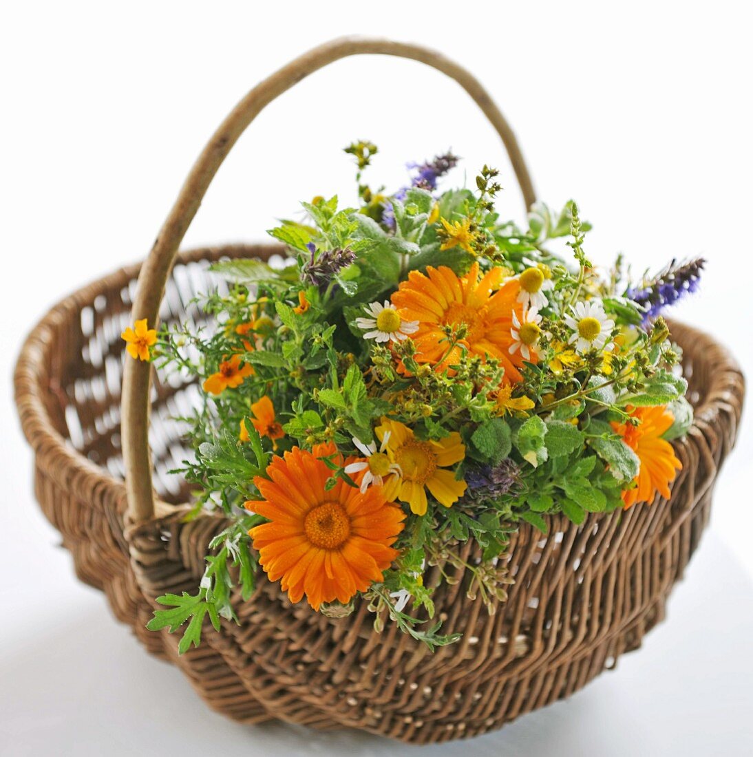 Bouquet of garden flowers in a wicker basket