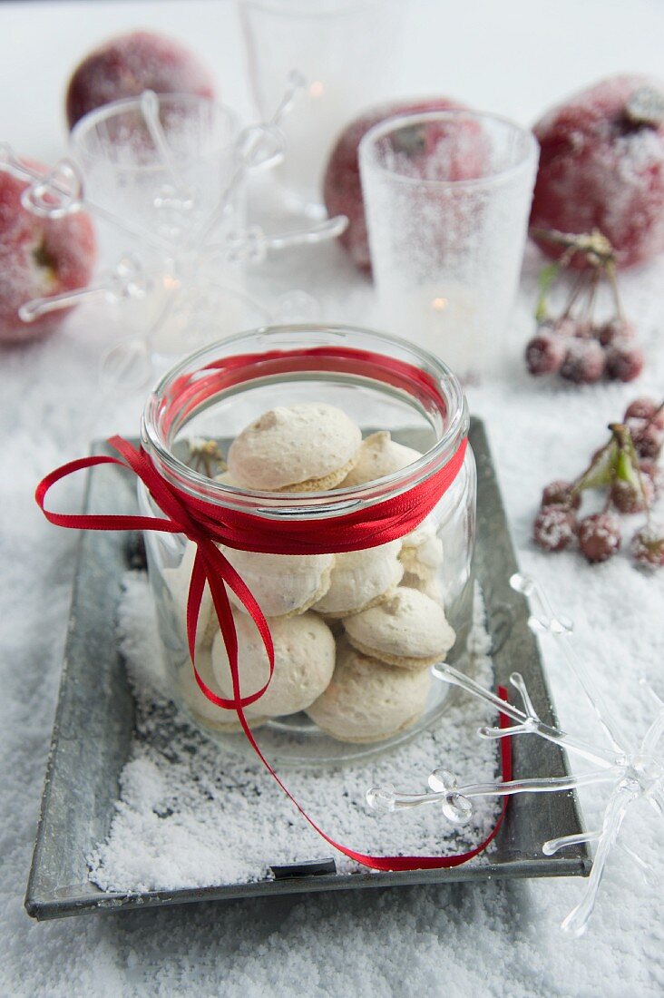 Jar of aniseed biscuits on tray in artificial snow