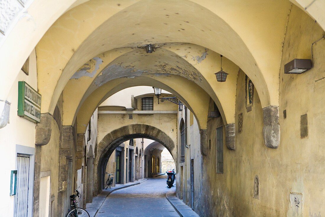 Vaulted arcades in Italian alleyway