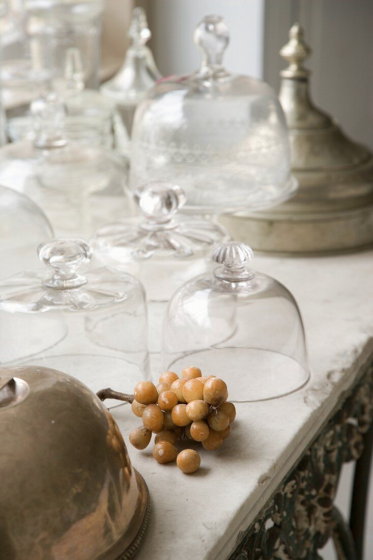 Assorted vintage-style glass domes on an old stone tabletop